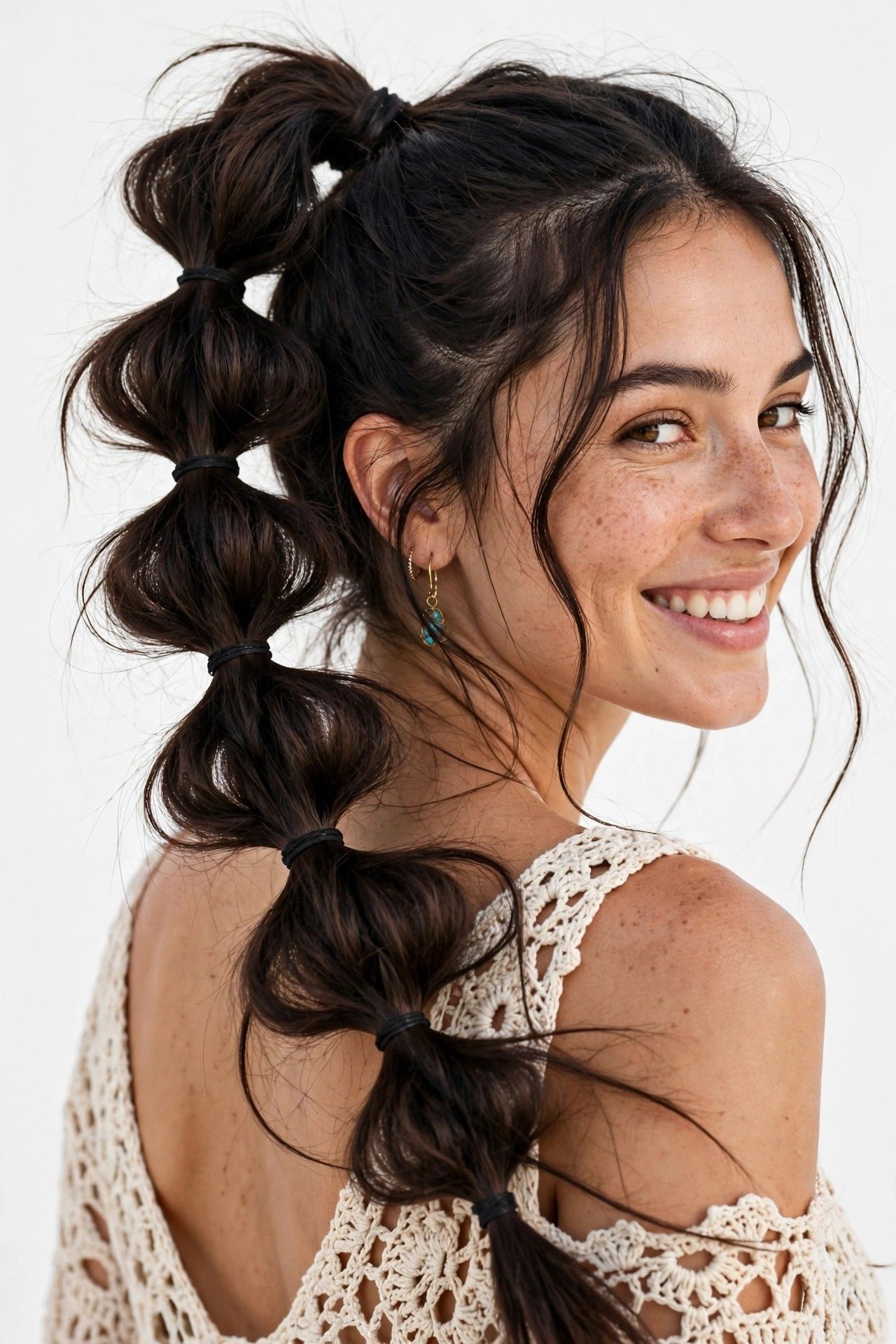 Boho bubble braid with soft pulled sections, playful segmented braid, dark hair, free-spirited look