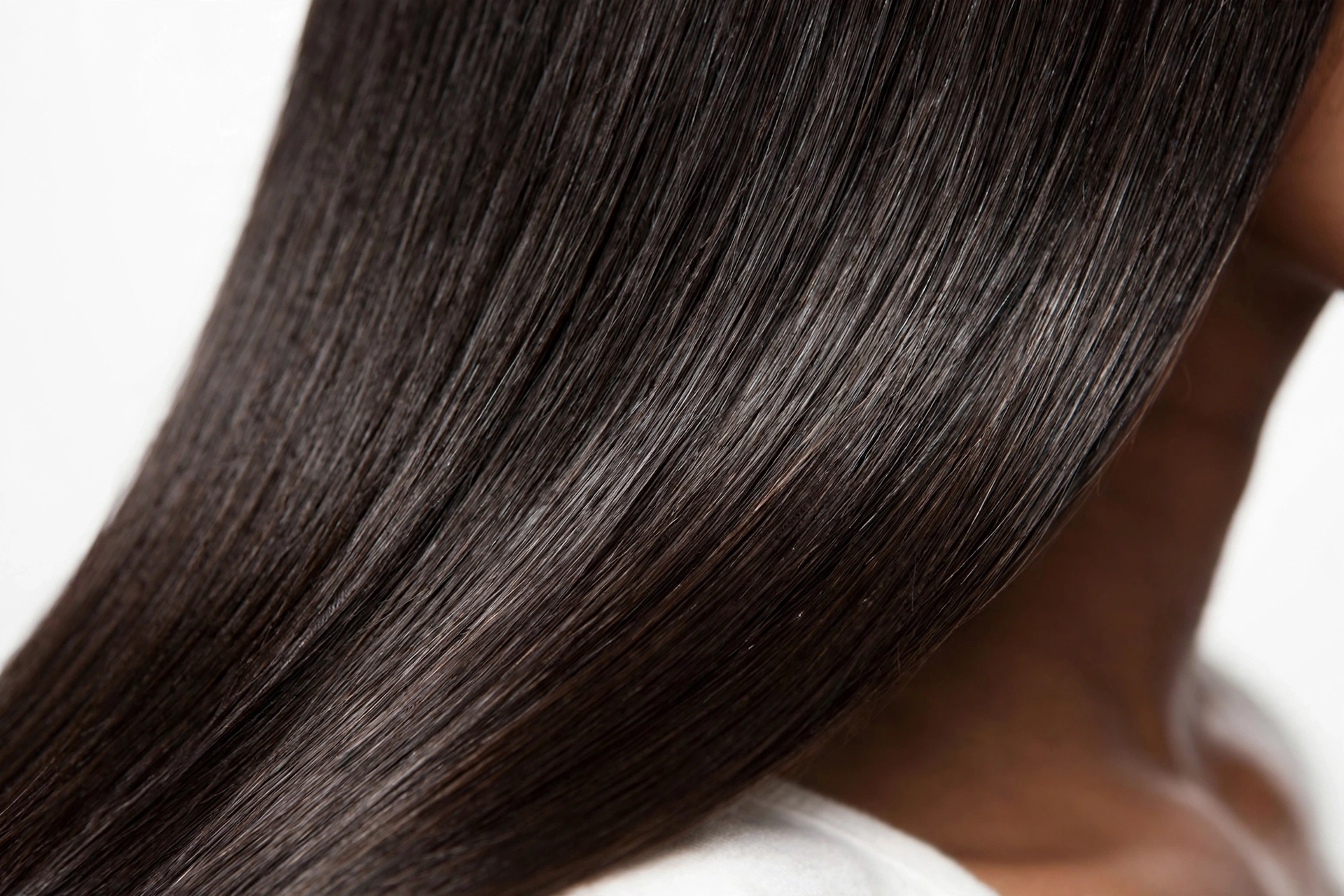 Close-up of healthy shiny silk press hair showing no heat damage